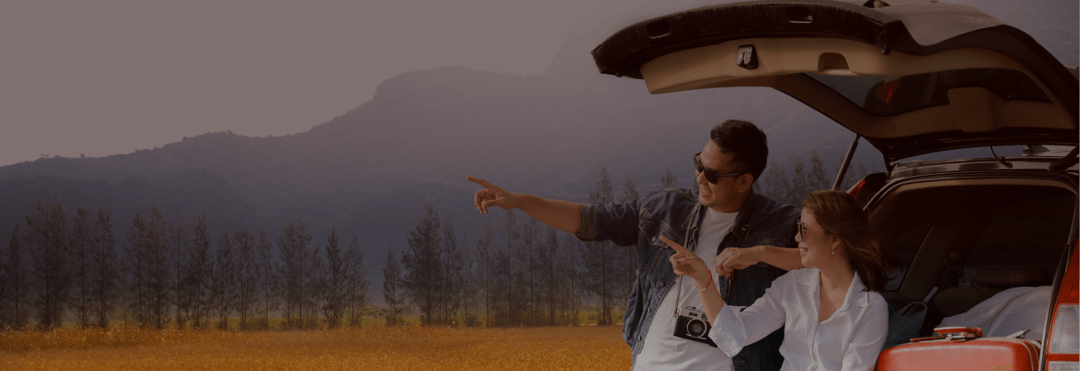 A couple sitting in the back of a newly purchased car