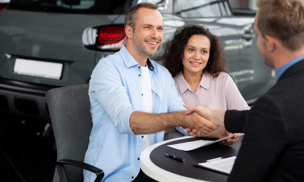 An engineer showing a customer car under hood