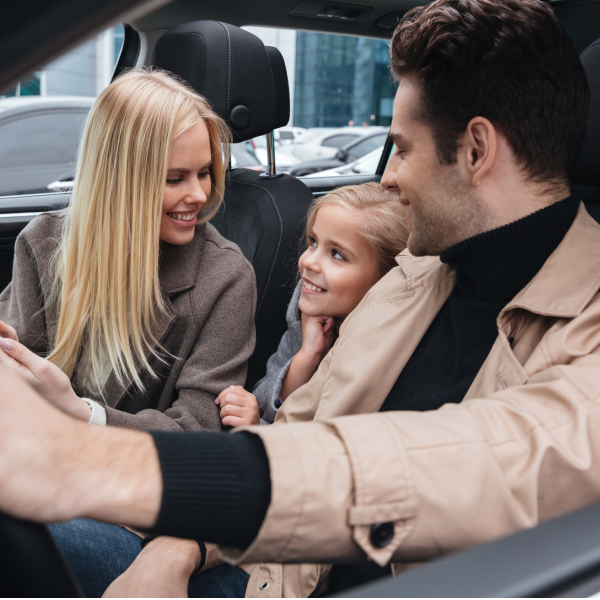 A family smiling in a car